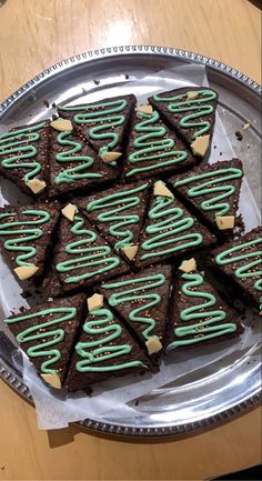 there are many brownies that have green icing on them, and they look like christmas trees