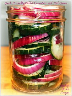 a jar filled with sliced up vegetables on top of a wooden table