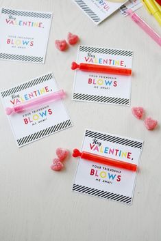 valentine's day gift tags with candy on the table next to pencils and markers