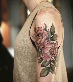 a woman with a flower tattoo on her arm