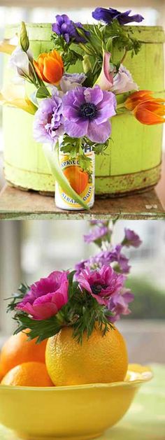 there are flowers and oranges in the bowl on the table next to each other