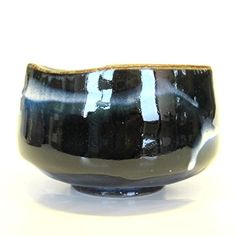 a black and white bowl sitting on top of a table