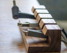 an electronic device is plugged in to a charger on a wooden table top