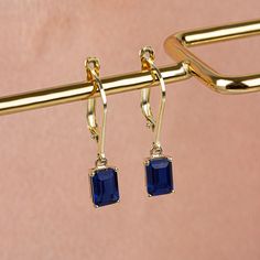 "Sapphire is also known as the \"stone of legends\". Since ancient times it has been seen as a symbol of seriousness, devotion and loyalty. The color of those born in September is the color of Sapphire. Our 14K solid gold and rectangular cut dangling sapphire earring is suitable for daily use with its special design and is a stylish jewelery that you can use on your special days and gift it to your loved ones. A stylish jewel for you and your loved ones. Time to pamper yourself and your loved on Gold Plated Jewelry For Pierced Ears In Rectangular Shape, Gold Plated Gemstone Jewelry In Rectangular Shape, Gold Plated Rectangular Gemstone Jewelry, 14k Gold Rectangular Birthstone Jewelry, Sapphire Jewelry With Rectangular Stone For Gift, Rectangular Single Earring For Gift, Sapphire Earring, Birthstone Gifts, September Birthstone