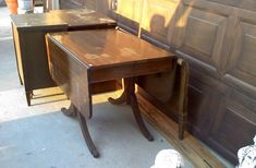 two wooden desks sitting next to each other in front of a garage door