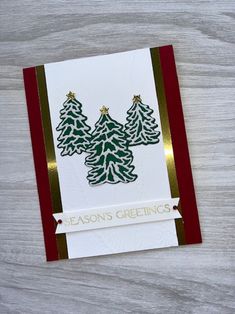 a christmas card with pine trees on it