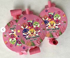 two baby shark fans with pink bows on the sides and matching labels for each fan