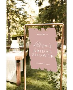 a welcome sign for a bridal shower is displayed in front of an outdoor table