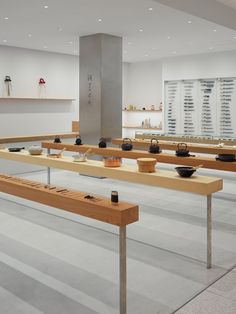 a room filled with lots of wooden tables and bowls