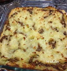 a casserole dish with meat and cheese in it