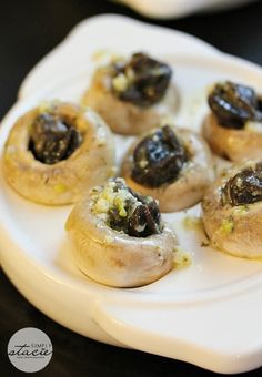 small pastries with olives on a white plate