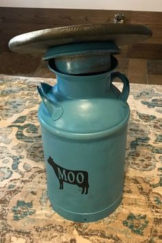 a blue canister sitting on top of a rug