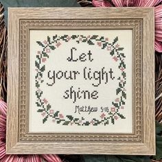 a cross stitch sample with the words, let your light shine on it and flowers