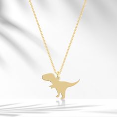 ❤️🦕 Solid Gold  Dino Minimalist Necklace 🦕❤️ 🦕 Cute Dino Tyrannosaurus Necklace 🦕  Dinosaurs may be extinct from the face of the planet, but they are alive and well in our imaginations.❤️ Details of the Product. Weight: Approximately 1,47g Cute minimalist Necklace. - All of our products are handmade produced of 8K, 14K, 18K real gold. The certificates of the diamonds we use in our products will be delivered by the cargo together with your orders. - Make sure you choose the right size and color before completing your order. If there is a preference you want to change, please contact us via message before your order is shipped. - All of our products are delivered to cargo within 1-6 working days. - Comes in a fancy jewelry box. - Your orders are under the responsibility of Venta Jewelry Dino Necklace, Small Gold Necklace, Dinosaur Pendant, Cute Dino, Jewelry Delicate, Fancy Jewelry, Minimalist Necklace, Animal Jewelry, Gold Pendant Necklace