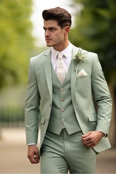 a man in a light green suit and white shirt is looking away from the camera