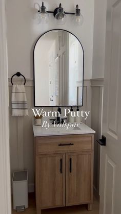 a bathroom with a large mirror above the sink