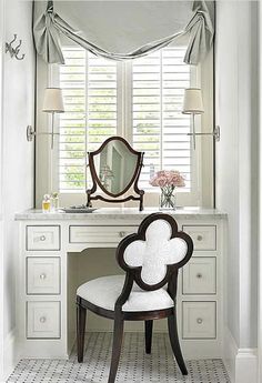 a white desk with a mirror and chair in front of it