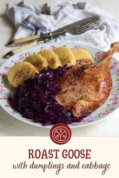 roast goose with dumplings and cabbage on a plate next to silverware, fork and napkin