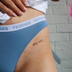 a woman's stomach with the word tennis written on her lower back and right side