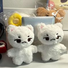 two white teddy bears sitting next to each other