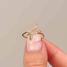 Dive into elegance with our 14k Solid Gold Dolphin Ring. A tribute to these intelligent creatures, it's a wearable work of art. Crafted with love, it's the perfect ocean lover's gift. Ring Details ❥ Gold KT: 14k Solid Gold ❥ Gold Color Options: White Gold, Yellow Gold, Rose Gold ❥ Top Width: 12.35 mm ❥ Band Width: 1.26 mm ❥ Thickness: 1.33 mm ❥ Gemstone: AAA Grade White Cubic Zirconia ❥ Ready to Ship in 4-7 Business Days MORE FROM US Statement Rings: https://etsy.me/3bb0QYW More about my shop: https://etsy.me/3mwMnsA ESSENTIAL INFORMATION 💎 BRENNMORE pieces are handcrafted by 15-30 years of experienced craftsmen and made to order. 🎁 All pieces come in a special turquoise gift box wrapped beautifully with a ribbon 🌎 All of our materials are ethically sourced and eco-friendly! Boxes are m Widgets Idea, Evil Eye Ring Gold, Rose Gold Top, Dolphin Ring, Mermaid Ring, Sea Jewelry, Gold Wrap, Braided Ring, Ocean Jewelry