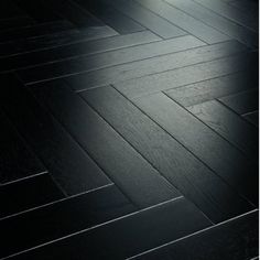 an image of a black wood floor with light coming in from the top right corner