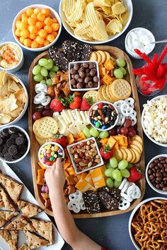 a platter filled with different types of snacks and crackers on top of it