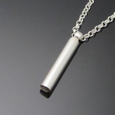 Eiremento Keepsake jewelry is a discreet way to keep the memory of your loved one close to you at all times. Large Tube cremation jewelry.The large tube keepsake pendant is completely handmade and comes on a heavyweight belcher chain. The keepsake pendant is crafted using the finest precious metals to ensure it lasts a lifetime. The bail discreetly twists off to allow for filling.Each piece is designed and made in Ireland using the highest quality precious metals.Available with a choice of chain Pendant Minimalist, Ashes Necklace, Belcher Chain, Cremation Jewelry, Keepsake Jewelry, Memorial Jewelry, Jewelry Pendant, Silver Cross, Animal Jewelry