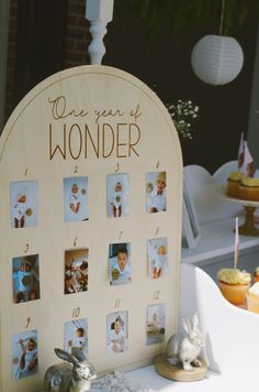 a wooden calendar sitting on top of a table next to cupcakes and cakes