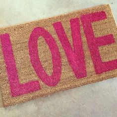 a door mat with the word love painted on it