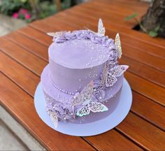 a purple cake sitting on top of a wooden table