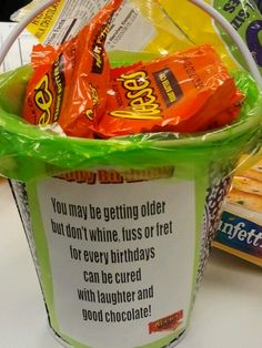 a bucket filled with candy sitting on top of a table