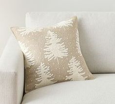 a white couch with a decorative pillow on it