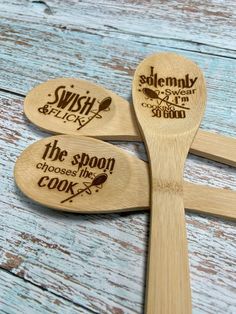 three wooden spoons with different designs on them