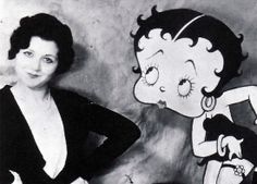 a black and white photo of a woman standing next to a cartoon character