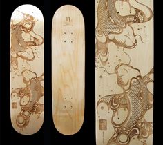 two wooden skateboards with designs on them