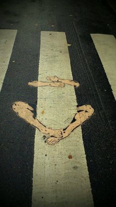 an image of the crosswalk that is painted on it's side and has been vandalized to look like a human hand