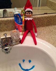 an elf is sitting in the sink with toothpaste