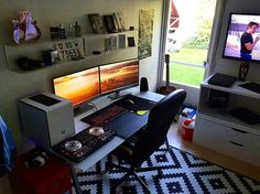 a computer desk with two monitors on top of it