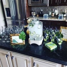 a kitchen counter topped with lots of wine glasses and cucumber slices on top of it