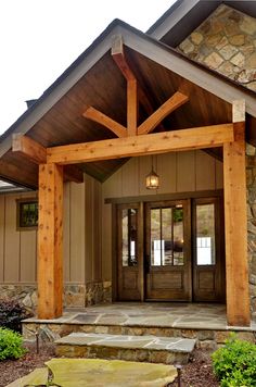 the front entrance to a home with stone steps