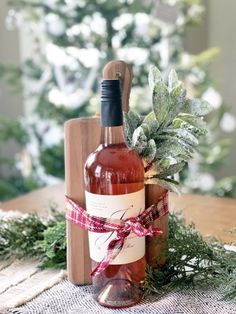 a bottle of wine sitting on top of a table next to a wooden cutting board