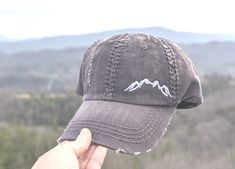 Need to change this cap design to a messy bun/high ponytail cap style, a non-distressed baseball cap or kid's baseball cap? Once you have this cap in your cart, head here: https://etsy.me/2S82fka Distinct Headwear Presents... 🌄Women's Embroidered Mountain Shape Silhouette Hat All hats are embroidered in the Smokies of East Tennessee. 🏞️Main Photo Shows: dark grey cap with white mountains. Order as shown or choose your cap and mountains thread color. Need this design with custom text? https://e Embroidered Mountains, Baseball Mom Hat, Bun High, Camping Hat, Cricket Crafts, Cc Hats, Mountain Hat, Ponytail Cap, Kids Baseball Caps