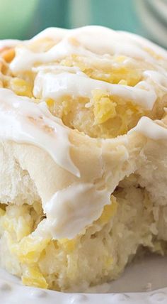 a close up of a piece of cake on a plate with frosting and nuts