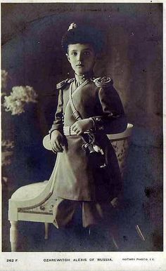 an old black and white photo of a young boy in uniform