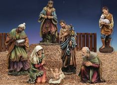 the nativity figurines are sitting on hay