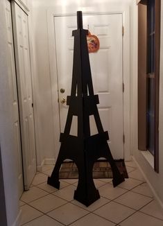 the eiffel tower is made out of wood and stands in front of a door