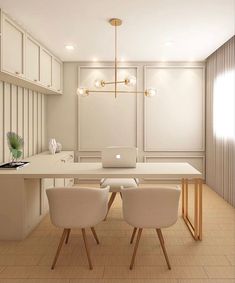 a laptop computer sitting on top of a wooden table in a room with white walls