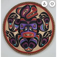 a wooden plate with an image of a totema on it