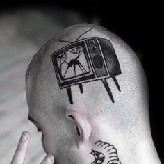 a man with a tv tattoo on his head